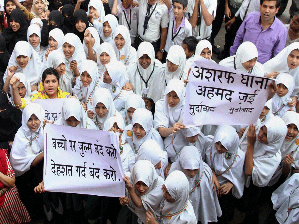 School girls take part in a protest against attack at a Peshawar school, at Mumbra near Thane, Mumbai on Wednesday. PTI Photo