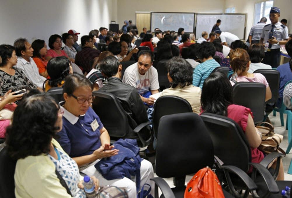 Family of passengers onboard AirAsia flight QZ8501 sit at a waiting area in Juanda International Airport, Surabaya December 28, 2014. Indonesia's air force was searching for the AirAsia plane carrying 162 people that went missing on Sunday after the ...