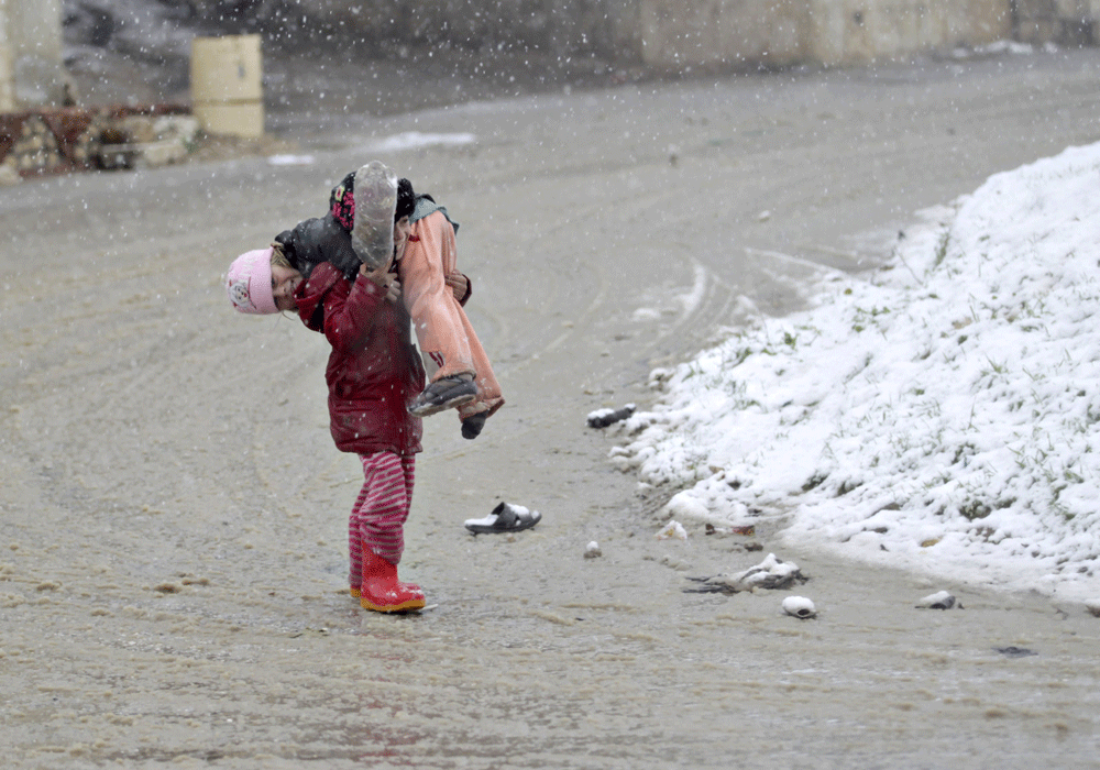 Syrian children play during a snow storm in Kvromh village in Idlib province January 15, 2015. 