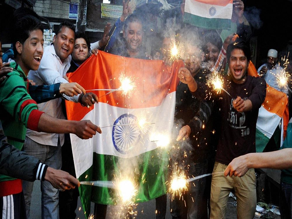 Cricket fans celebrate after team India's victory in the ICC World Cup Pool B match against Pakistan, in Amritsar on Sunday. 