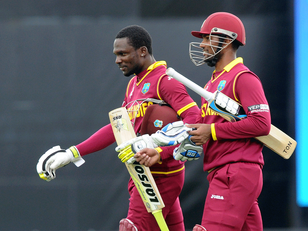 West Indies batsmen Denesh Ramdin  walks with Jonathan Carter after they won their Cricket World Cup Pool B match by six wickets against the United Arab Emirates in Napier, New Zealand. AP Photo.