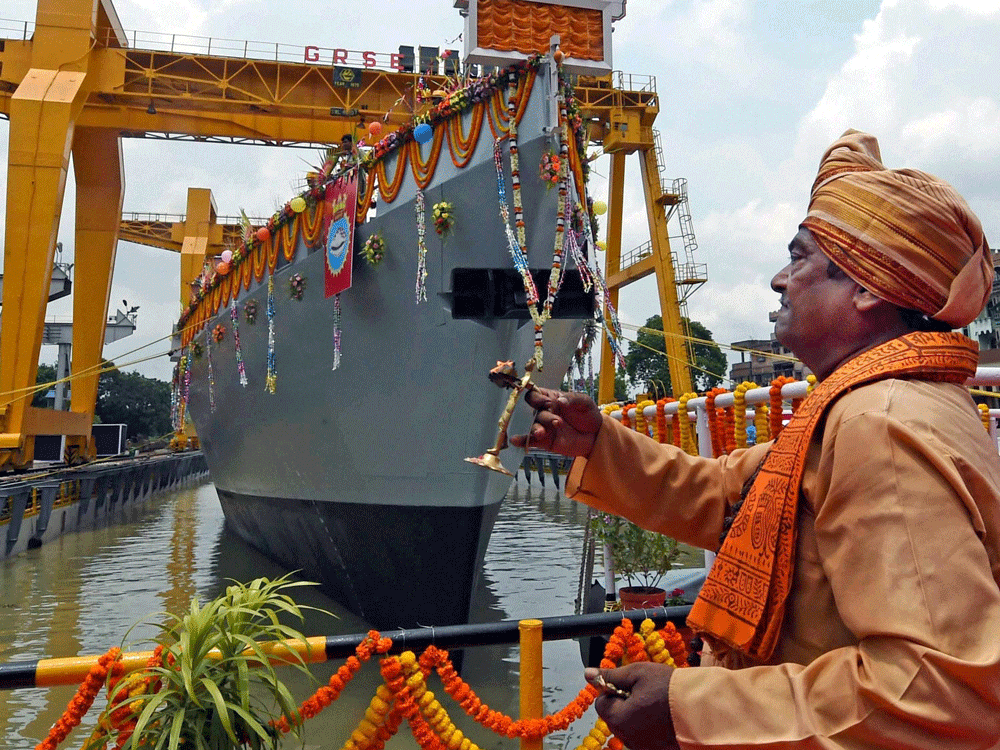 A priest performs prayers during launch of Anti Submarine Warfare(ASW) Corvette in Kolkata on Tuesday. PTI Photo