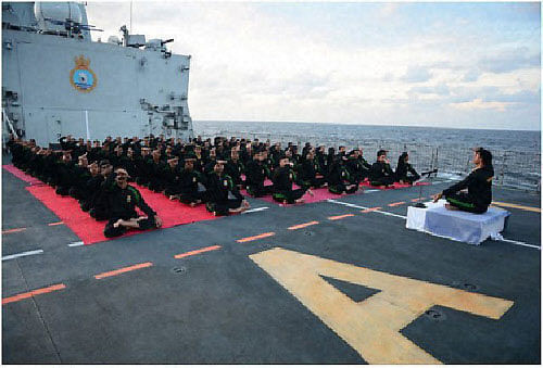 Navy personnel at a Yoga session onboard INS Kamorta in Malaysia on Wednesday. PTI Photo