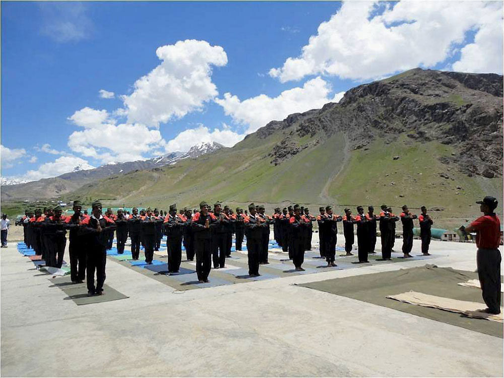 Army personnel practice Yoga at Northern Command on the eve of Yoga Day in Ladakh on Saturday. PTI Photo.