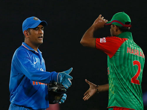 India’s captain M S Dhoni  greets Bangladesh’s captain Mashrafe Mortaza after winning their third one-day international cricket match in Dhaka, Bangladesh, Wednesday, June 24, 2015. AP Photo.