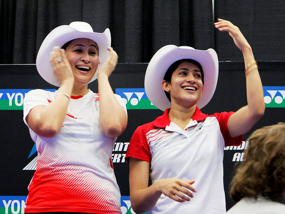 India's Jwala Gutta and Ashwini Ponnappa pose for photographs after winning Canada Open women's doubles title in Calgary, Canada . 