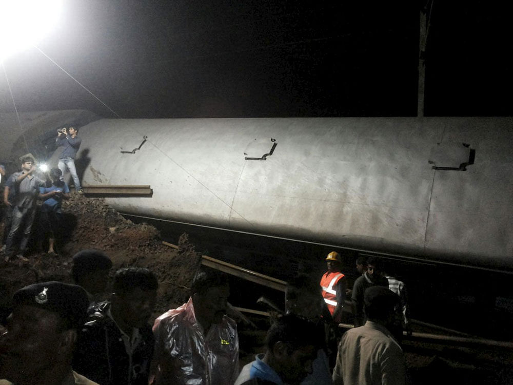 Police and members of the rescue operation stand at the site of a train derailment near Harda, Madhya Pradesh. Reuters