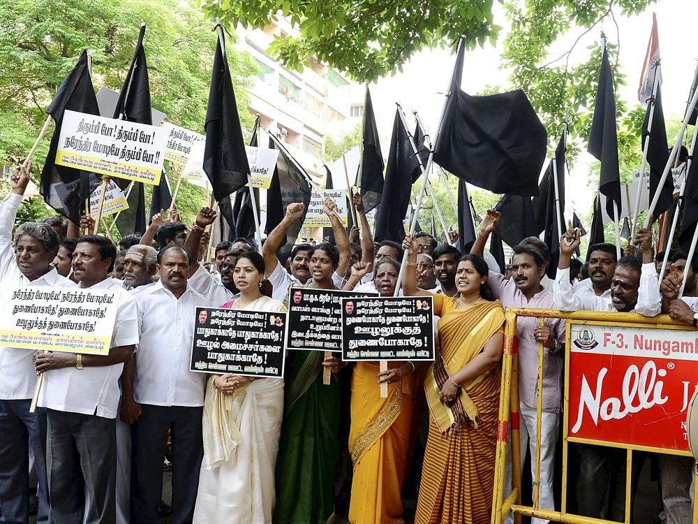 Tamil Nadu Congress Committee President E V K S Elangovan along with party leaders stage a protest by showing black flags and placards reading 'Modi Go Back' agsint suspension of Congress MPs in the Parliament, after the arrival of Prime Minister Nar...