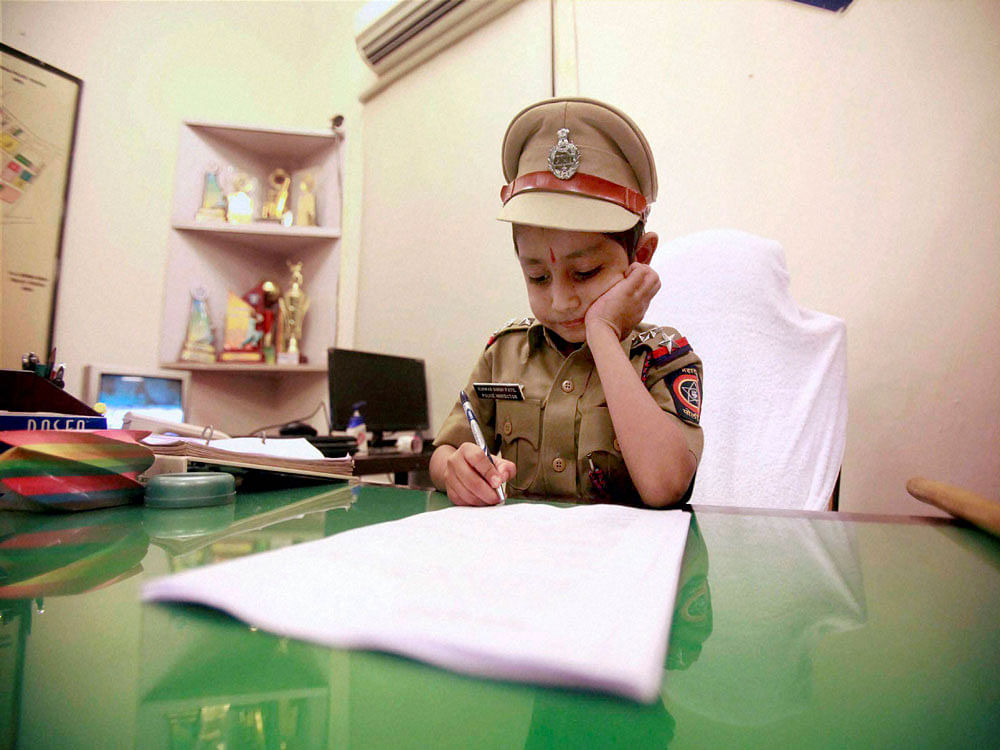 Cancer patient Kunwar Singh Patil who was made a police officer for a day as per his wish, occupies senior inspector’s chair in Mumbai on Monday. PTI Photo