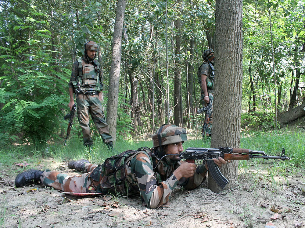  Army jawans take positions during an encounter between security forces and two suspected Lashkar-e-Toiba (LeT) militants at Peerbagh Ratnipora in south Kashmir’s Pulwama district on Tuesday. PTI Photo.