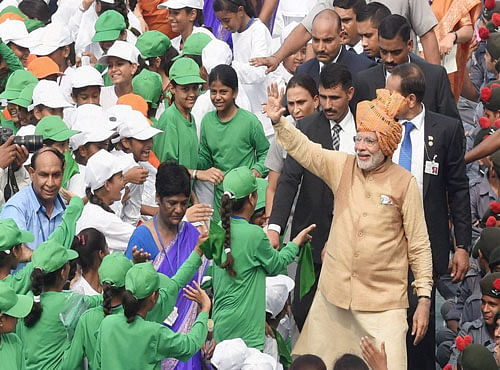 Prime Minister Narendra Modi interacts with school children after his address to the nation during the 69th Independence Day Celebrations at the historic Red Fort in New Delhi on Saturday. PTI