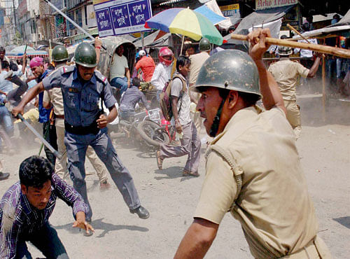 Police lathicharge civic volunteers during their agitation in Malda district of West Bengal on Monday. PTI Photo