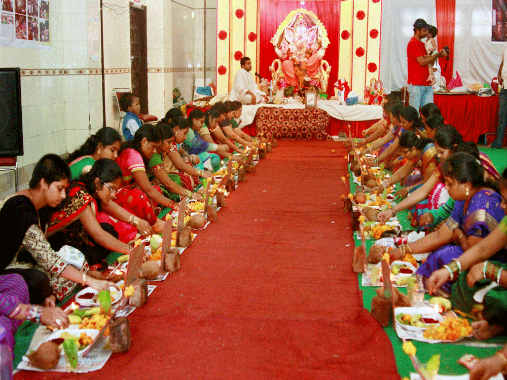 Women offer prayers to Lord Ganesha during Sri Laxmi Ganapathi Kumkum Pooja Archana organised by Telugu Welfare Association on the occasion of Ganesh Utsav in Gurgaon on Friday. PTI Photo.