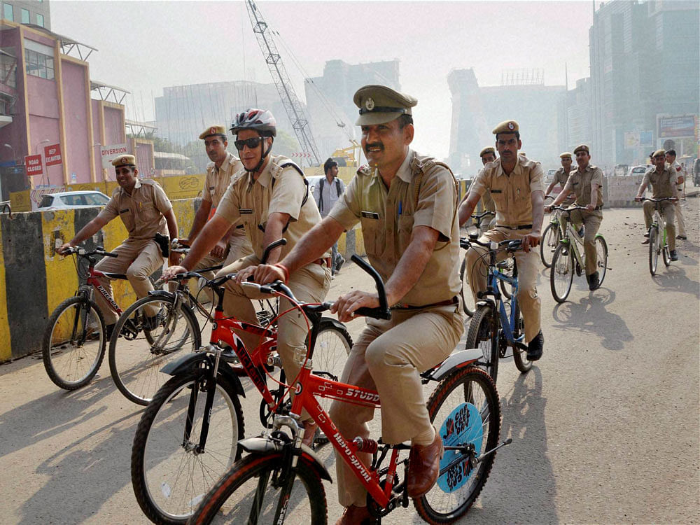 Police officials riding bicycles to create awareness for 'Car Free Day' in Gurgaon on Tuesday. PTI Photo