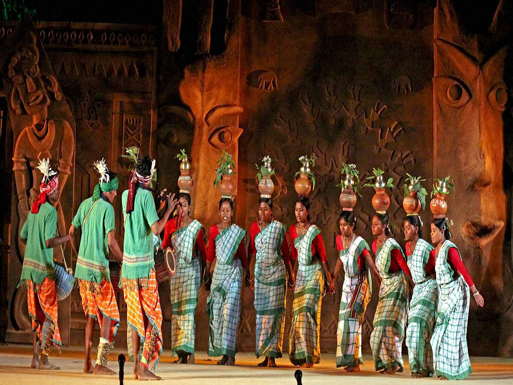 Tribal artists of West Bengal performing folk dance during the 'Adi Bimb' Festival of Tribal Dance, Music and Theater organized by National School of Drama (New Delhi) at Dwaronda in Birbhum district of West Bengal on Wednesday evening. PTI Photo