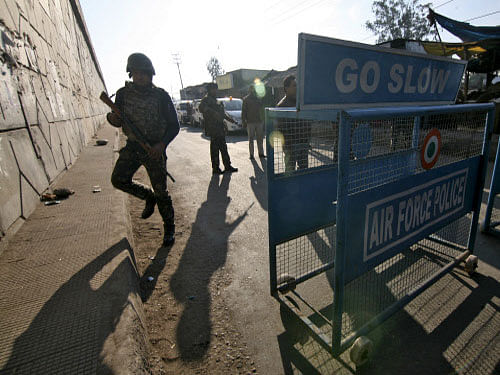Security personnel stand guard next to a barricade outside the Indian Air Force (IAF) base at Pathankot in Punjab. At least four gunmen and a two IAF personnel were killed in an attack on an Indian Air Force base on Saturday near the border with Paki...