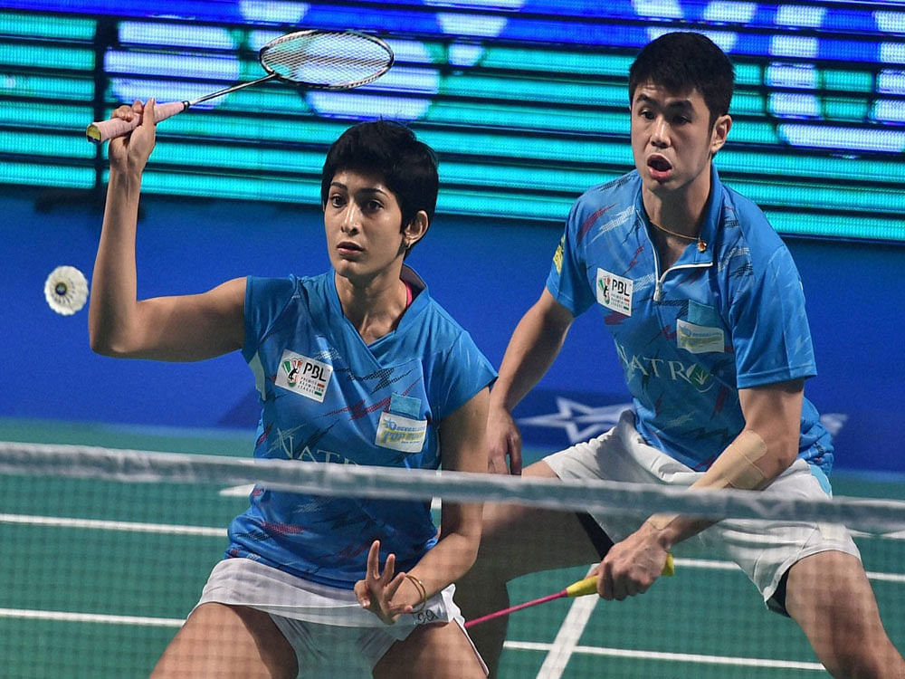 Bengaluru Topguns Ashwini Ponnappa and Khim Wah Lim play against Delhi Acers Gabrielle Adcock and Koo Keat Kien during the Premier Badminton League's Mix doubles match in New Delhi on Friday. PTI Photo