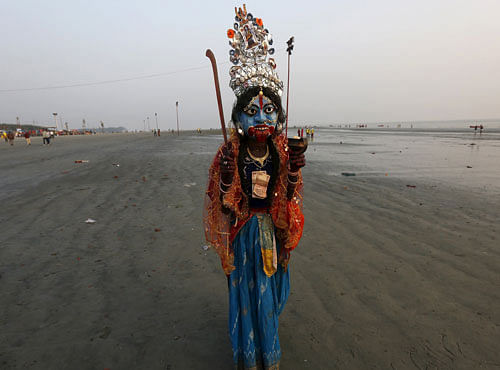 A man dressed as Hindu goddess Kali walks for alms from Hindu pilgrims ahead of the 'Makar Sankranti' festival at Sagar Island. Reuters