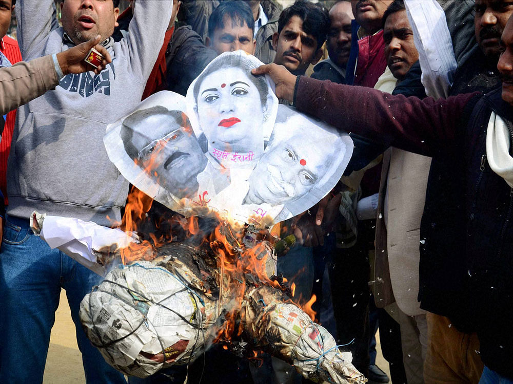  Protestors burn an effigy of HRD Minister Smriti Irani, Union Labour Minister Bandaru Dattatreya and Hyderabad Central University Vice Chancellor Appa Rao during a protest against the suicide of Dalit student Rohith Vemula, in Allahabad on Friday. ...