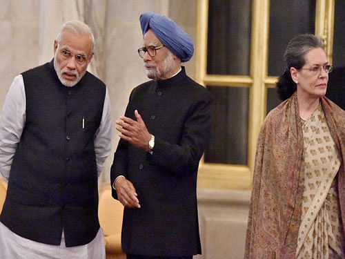 Prime Minister Narendra Modi and former PM Manmohan Singh talks as UPA chairperson Sonia Gandhi looks on during a banquet hosted in the honour of French President Francois Hollande, at Rashtrapati Bhavan in New Delhi on Monday. PTI Photo