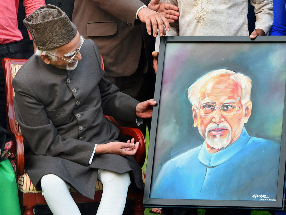 Vice President Hamid Ansari being presented a portrait by Tableaux artists of Republic Day Parade who met with him at his residence in New Delhi on Thursday. PTI Photo
