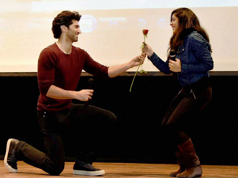 Actor Aditya Roy Kapoor with a girl during the promotion of his upcoming film ‘Fitoor’ at Gargi College in New Delhi on Wednesday. PTI Photo.