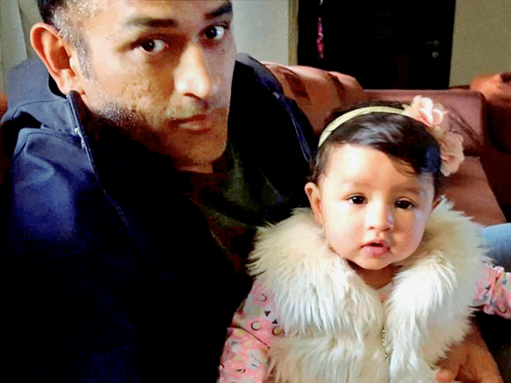 Cricketer Mahendra Singh Dhoni celebrating the first birthday of his daughter Ziva at his home 'Shourya' in Ranchi, Jharkhand on Saturday. PTI Photo.