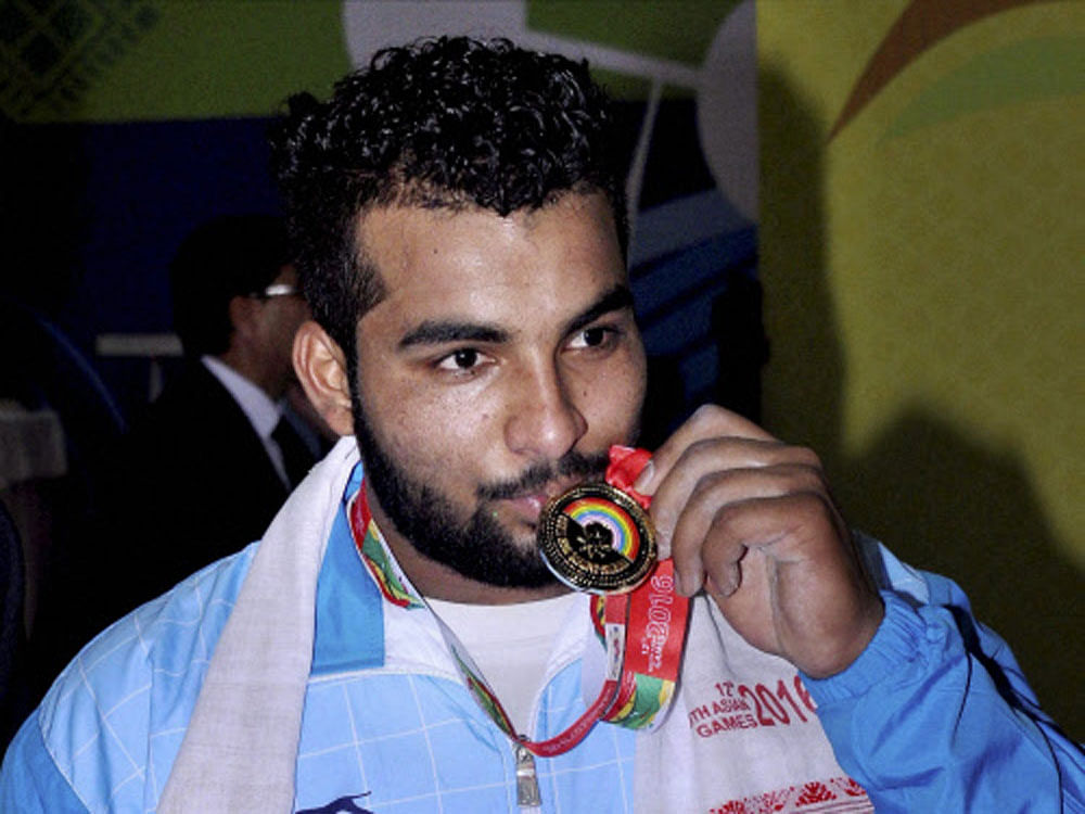  Weightlifter Pradeep Singh of India after winning gold in 94 kg wrestling at the 12th South Asian Games 2016 in Guwhati on Monday. PTI Photo