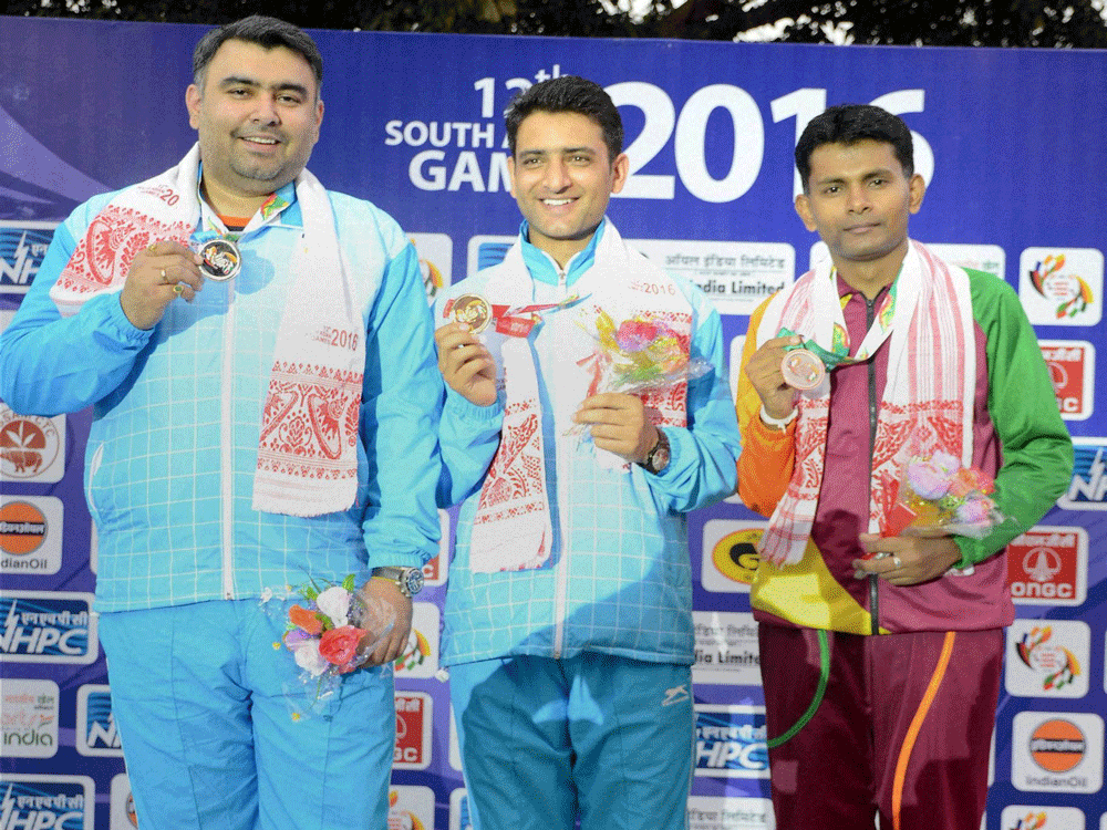  Gold Medal Winner Chain Singh (C) , Silver Medal winner Gagan Narang (L) of India and Bronze Medal Winner SMM Samarkoon (R) of Sri Lanka during the presentation ceremony after winning the 50m Air Rifle Mens Individual shooting event at the 12th Sou...