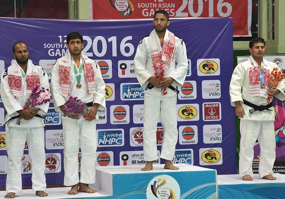 Gold medal winner India's Maan Karanjit Singh(2nd R),Faiz Zada Ajmal (AFG) silver and Qaiser Khan (PAK) and Md. Habibur Rahman (BGD) bronze at the presentation ceremony of the Judo below 81kg category of men's event at the 12th South Asian Games in G...