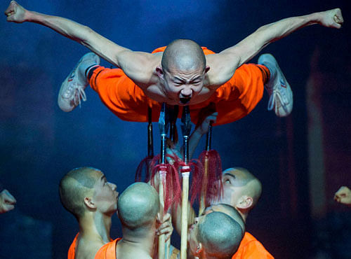 Shaolin monks perform during their Shaolin Warriors – The Magical Secret 20th Anniversary Tour at MOM Culture Center in Budapest, Hungary. PTI