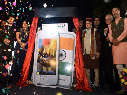 BJP Senior leader Murli Manhore Joshi ,Director of Ringing Bells, Mohit Goel and CEO, Dhaarna Goel during the launch of Smartphone-Ringing Bells Freedom 251, in New Delhi on Wednesday. PTI Photo by Manvender Vashist