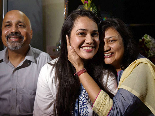 Tina Dabi who got the First rank in the Civil Services Exams 2015 with her parents at their residence in New Delhi on Tuesday. PTI Photo