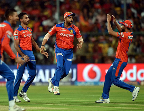Gujarat Lions bowler Dhawal Kulkarni with Suresh Raina celebrates the wicket of K L Rahul during the 1st qualifier IPL 2016 match against Royal Challengers Bangalore at Chinnaswamy Stadium in Bengaluru on Tuesday. PTI Photo