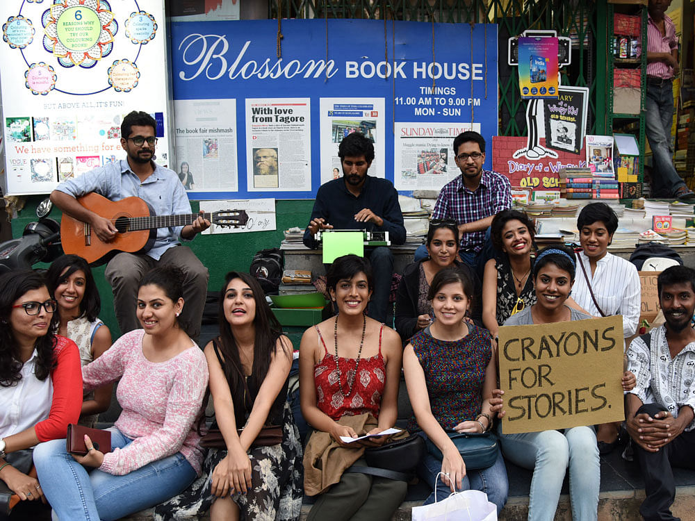 . Members of Global Concern India collecting donation by pencil, pen, crayons, books, mony etc... for Ashok Nagar Government School children in front of Blossom at Church Street in Bengaluru on Saturday. DH Photo.