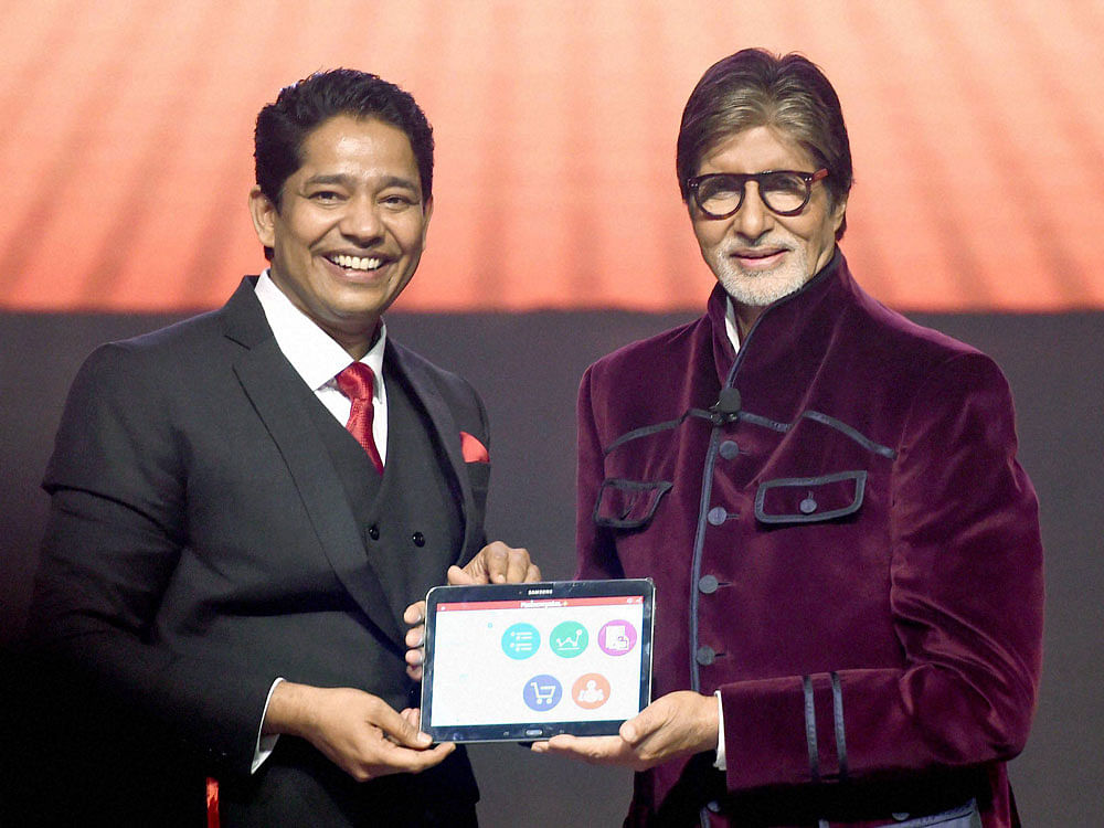 Mahesh Shetty, CMD of MD Educare and Bollywood actor Amitabh Bachchan during the launch of 'Robomate plus' mobile app in Mumbai on Sunday. PTI Photo.