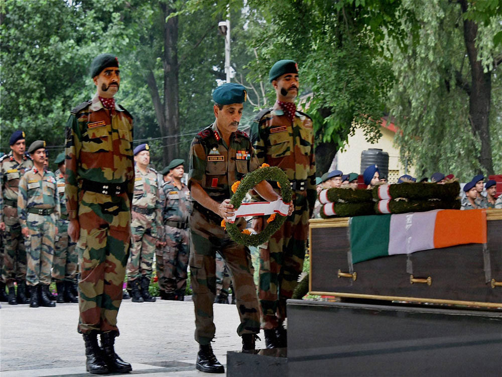  General Officer Commanding 15 corps Lt Gen Satish Dua pays tributes to soldier L/HAV Prem Bahadur Resmi Magar, during wreath laying ceremony, who was killed in a gun fight with militants in Tangdar Sector of Kupwara, at 15 corps head quarter Badami...