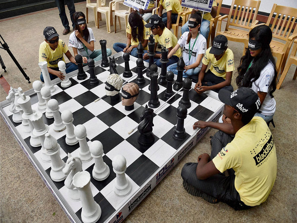 Blind folded students playing chess during a press conference to announce the Karnataka State level Blind Chess Competition 2016, to be held between 24th and 26th June, in Bengaluru on Friday.PTI Photo.