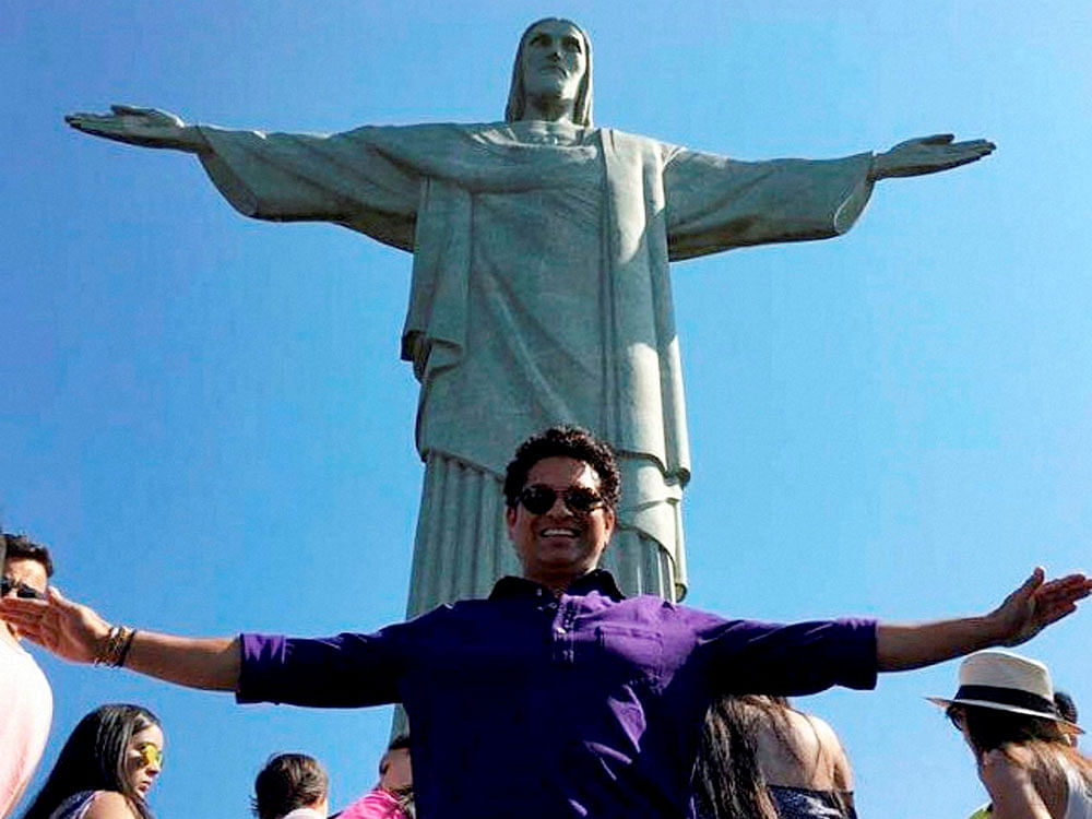 Sachin Tendulkar strikes a pose in front of Christ the Redeemer statue in Rio de Janerio on Saturday. PTI Photo