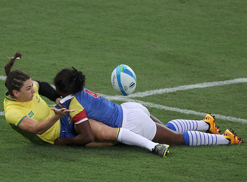 Tais Balconi (BRA) of Brazil tackles Khaterinne Medina (COL) of Colombia. REUTERS