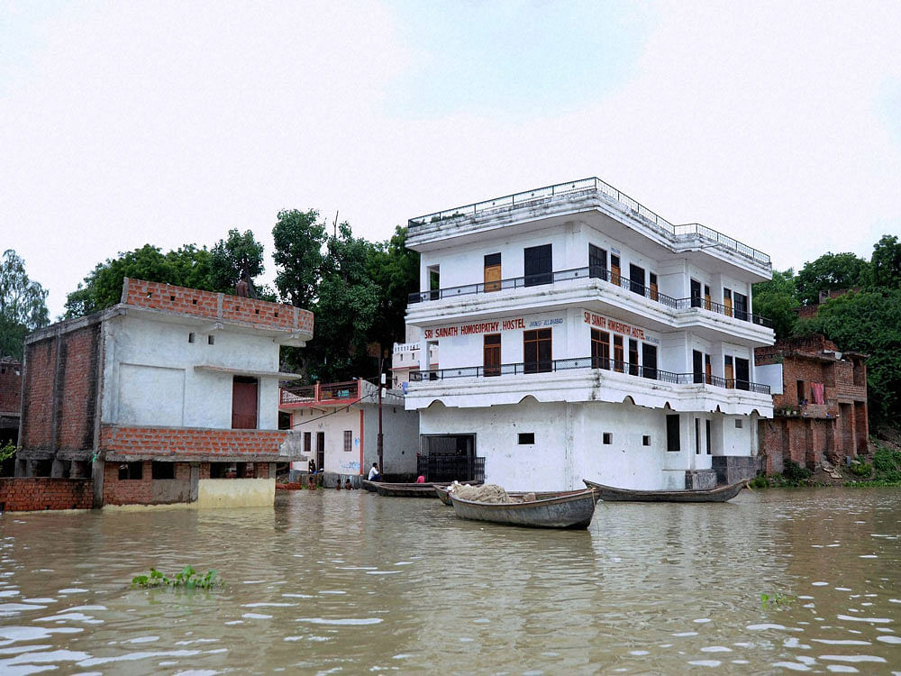 A view of flooded locality of Jhunshi area after water level of River Ganga and yamuna rouse in Allahabad on Wednesday. PTI Photo