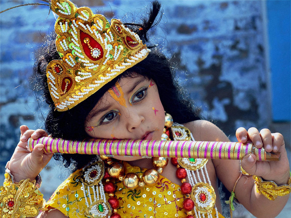 A child dresses as lord Krishna for a school function ahead of Janmashtami, in Bikaner on Wednesday. PTI Photo