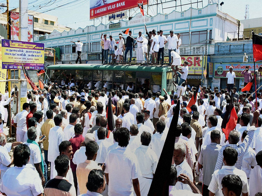 DMK cadres being detained who were staging a rail roko the Cauvery water row, in Madurai on Friday. PTI Photo