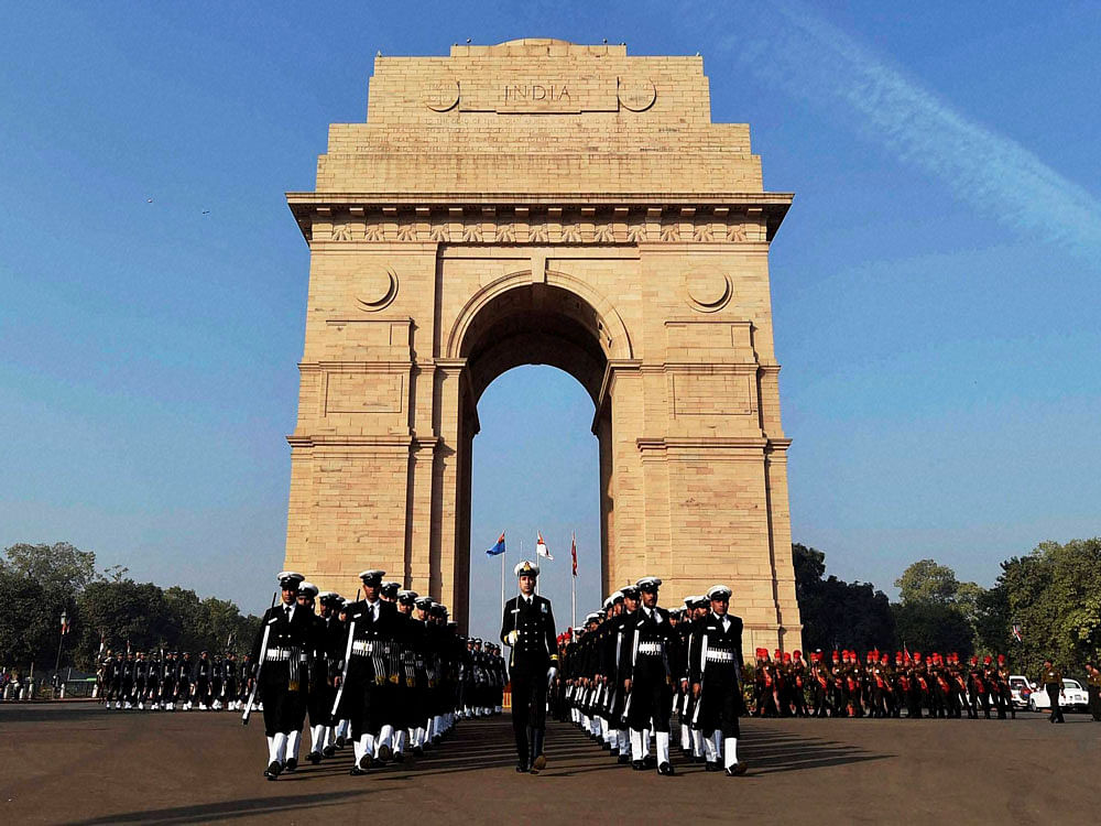Soldiers paying homage to martyrs at 'Amar Jawan Jyoti' at India Gate on the occasion of 'Vijay Diwas' in New Delhi on Friday. PTI Photo