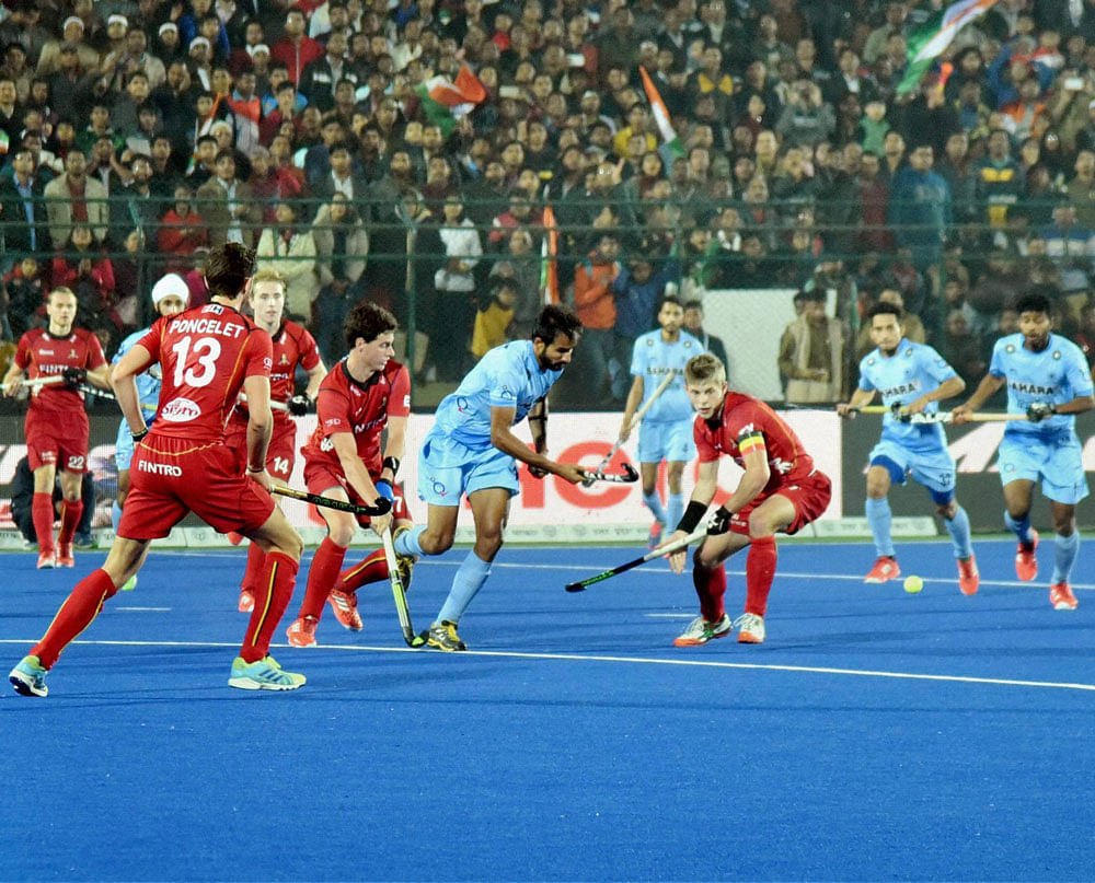 Indian (blue) and Belgium players in action during the Junior World Cup Hockey final match in Lucknow on Sunday. PTI Photo
