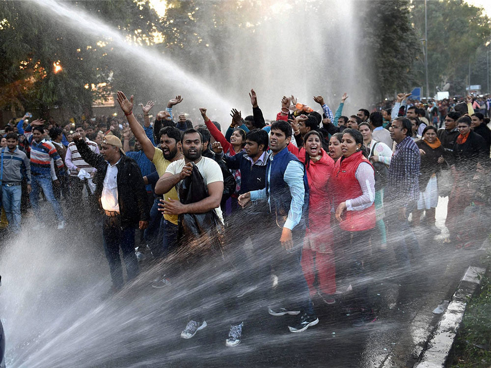 Police use water cannons to disperse scores of guest teachers who staged a protest against AAP government after a function outside North Delhi's Chhatarsal Stadium on Wednesday. The teachers got upset with Delhi Chief Minister Arvind Kejriwal for not...