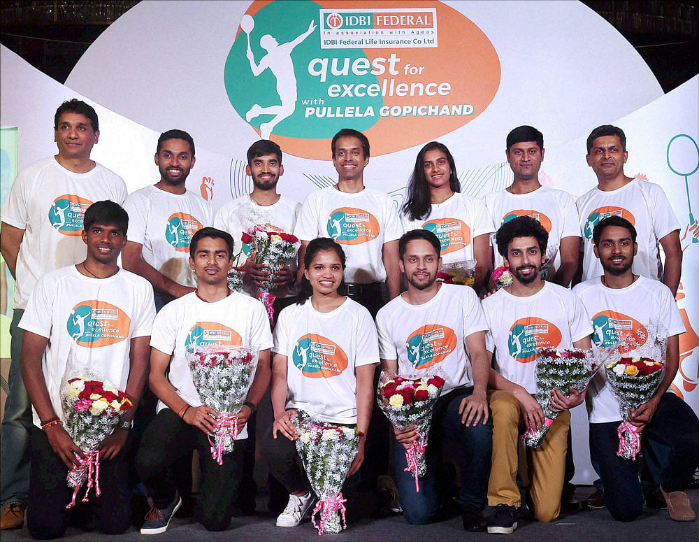 Badminton coach Pullela Gopichand and star shuttler PV Sindhu along with other players during a promotional event in Mumbai on Thursday. PTI Photo