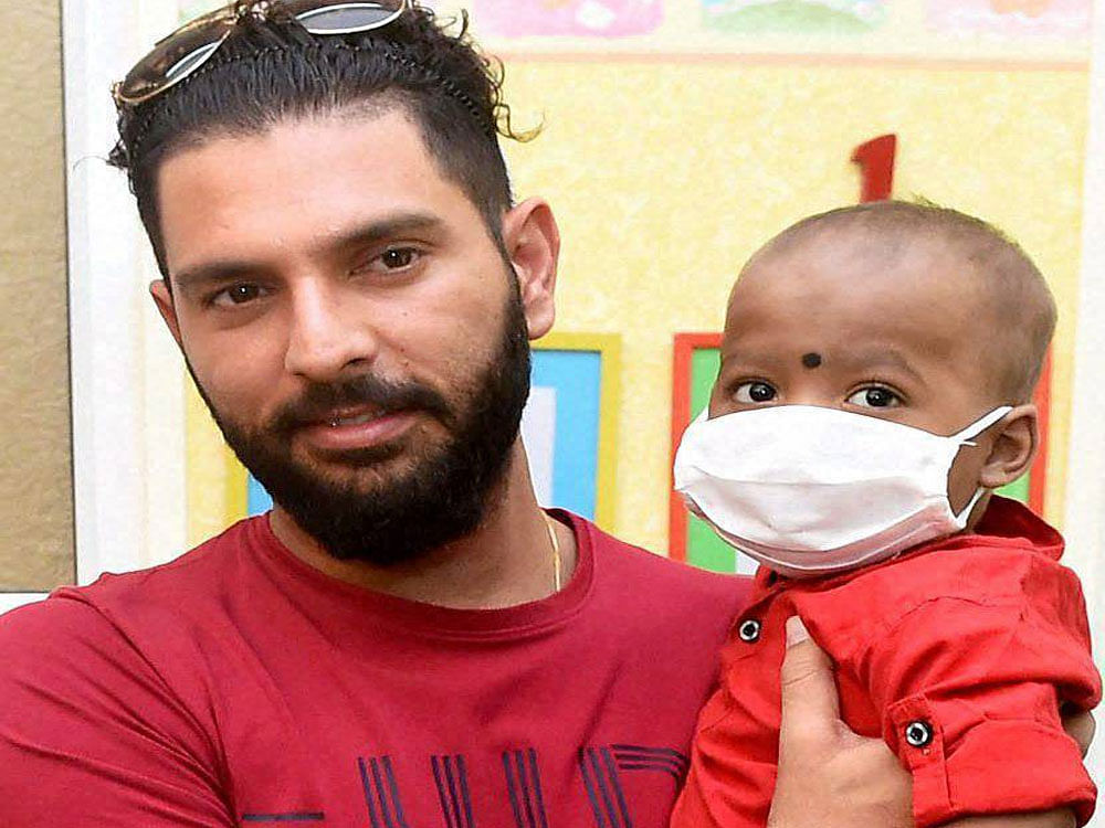 Indian cricketer Yuvraj Singh interacts with cancer suffering children at St. Jude India Childcare centre in Mumbai on Friday. PTI Photo