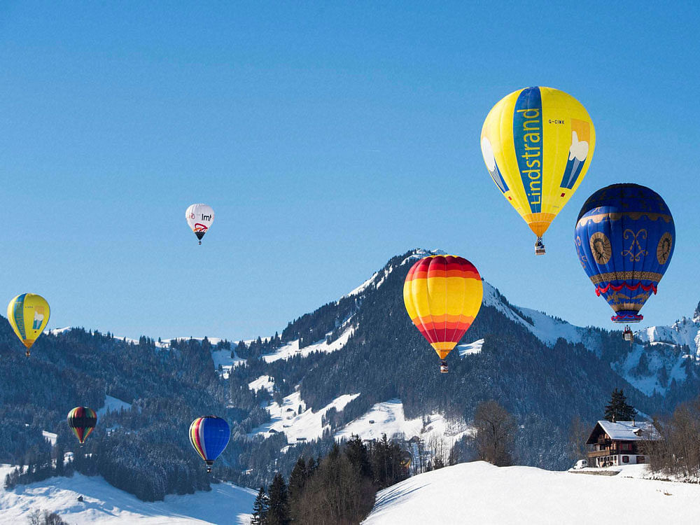  Hot air balloons fly during the 39th International Hot Air Balloon Week in Chateau-d'Oex, Switzerland. AP/PTI