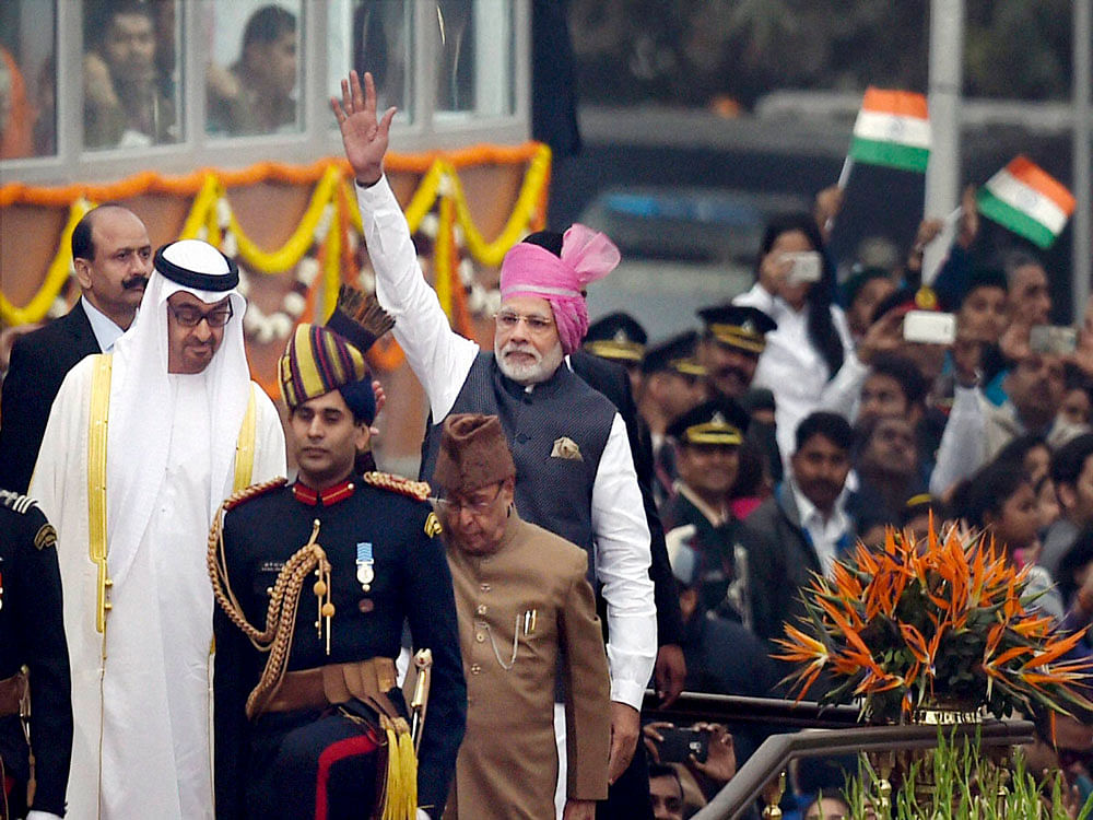 Prime Minister Narendra Modi waves to the crowd as President Pranab  Mukherjee and General Sheikh Mohammed Bin Zayed Al Nahyan, Crown Prince  of Adu Dhabi look on after attending the 68th Republic Day celebrations  at Rajpath in New Delhi on Thursday...